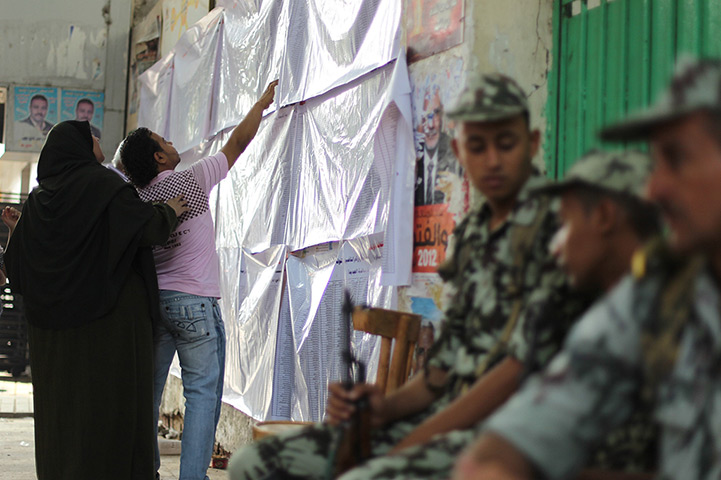 Egypt elections day 2: Voters check their names at a polling station in Cairo