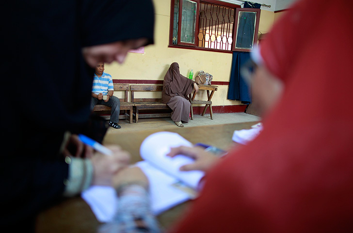Egypt elections day 2: An Egyptian woman marks her vote before casting it 