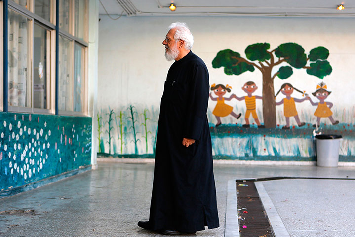 Greek elections: A Greek Orthodox priest waits to vote in Athens