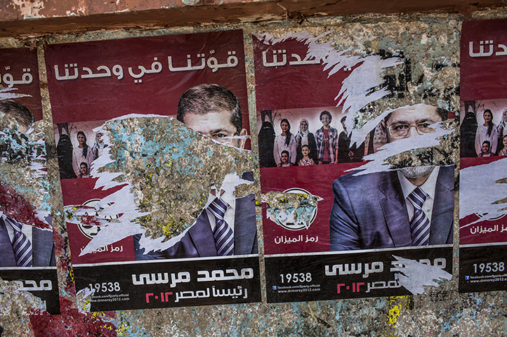 Egypt elections day 2: Torn campaign posters of presidential election candidate Mohamed Morsi 