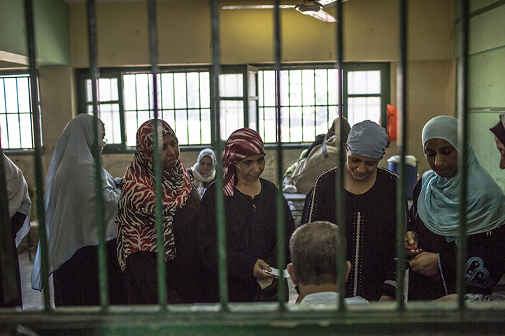 Egypt elections day 2: Egyptian women line-up to cast their vote at a polling station in Cairo