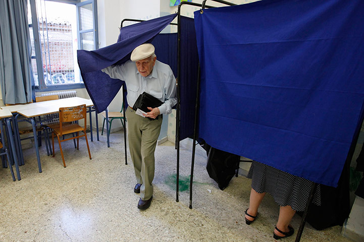 Greeks vote: An elderly man leaves the voting booth at a polling station in Athens