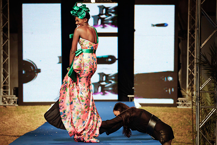 Dakar fashion week: A model reacts as her shoe on the runway