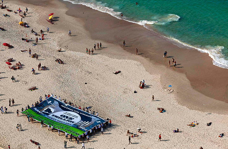 UN Rio+20: Activists hold up a banner depicting a $1 trillion note