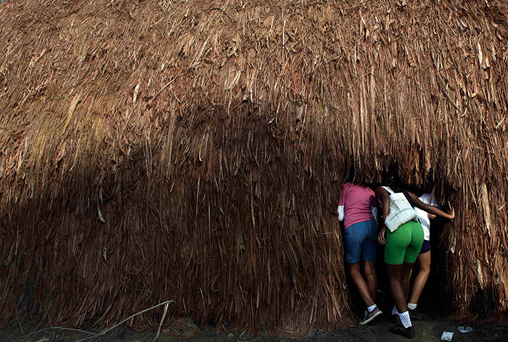 UN Rio+20: Students look inside a indigenous traditional house 