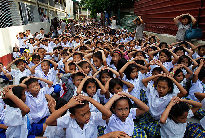 Picture desk live: Teachers and students cover their heads