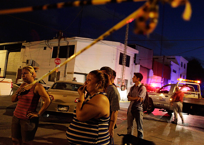24 hours in pictures: Relatives react at a crime scene where two men were gunned down