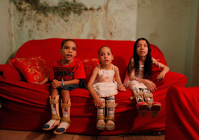 24 Hours: The children of the Amor Divino family sit on their couch in Sao Paulo