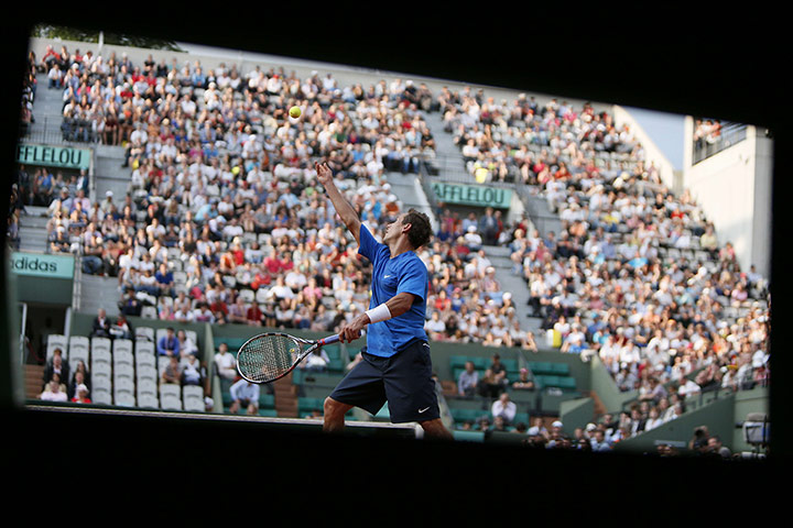 24 Hours: France's Nicolas Devilder serves to Serbia's Novak Djokovic