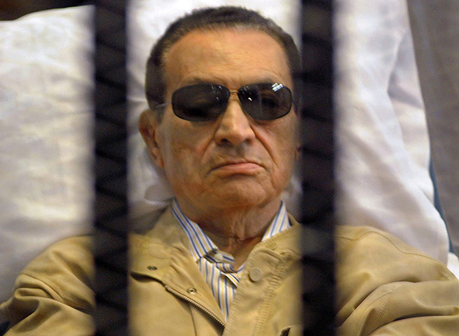 Mubarak Verdict Updated: Mubarak is seen in the defendants' cage as a judge reads the verdict