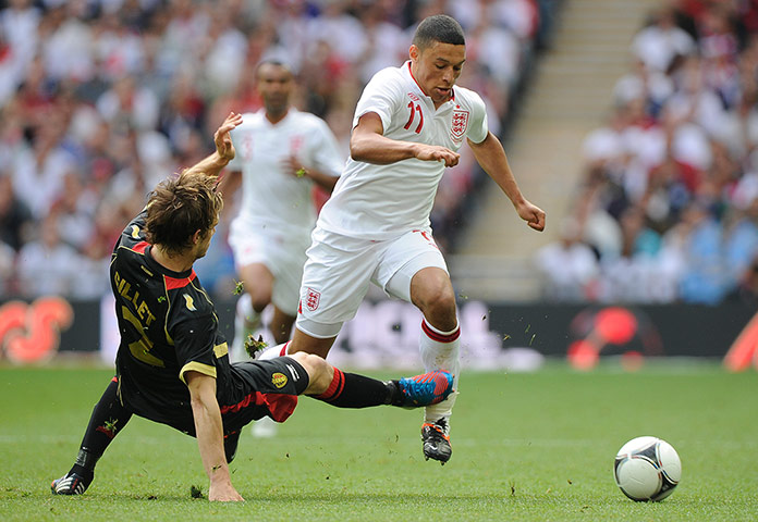 ENGLAND V BELGIUM:  Guillaume Gillet tries to tackle Alex Oxlade-Chamberlain