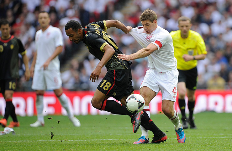 ENGLAND V BELGIUM: Steven Gerrard tussles with Moussa Dembele