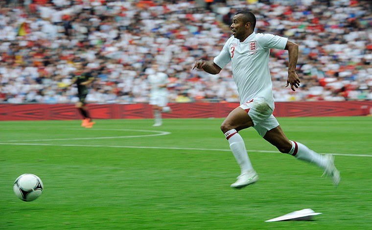 ENGLAND V BELGIUM: Ashley Cole sprints past a paper aeroplane