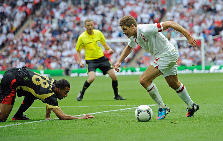 ENGLAND V BELGIUM: Steven Gerrard gets past the stranded Mousa Dembele 