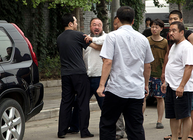 Picture desk live: Ai Weiwei outside his home in Beijing