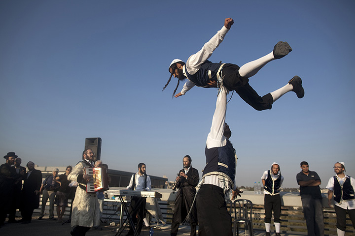 24 hours in pictures: Ultra-orthodox Jewish dancers perform