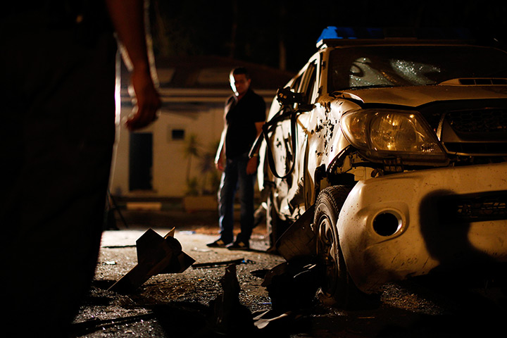 24 hours in pictures: Israeli security forces stand at the scene where a rocket exploded