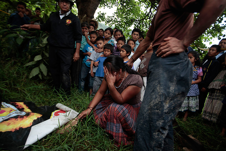 24 hours in pictures: Maura Castellanos touches the feet of her daughter Ana Victoria Chacon