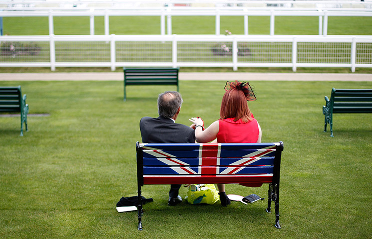 24 hours in pictures: Race goers sit on a bench painted with the Union Jack at Royal Ascot