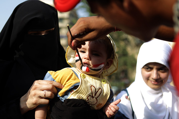 24 hours in pictures: Baby's face painted with the colours of the Egyptian flag