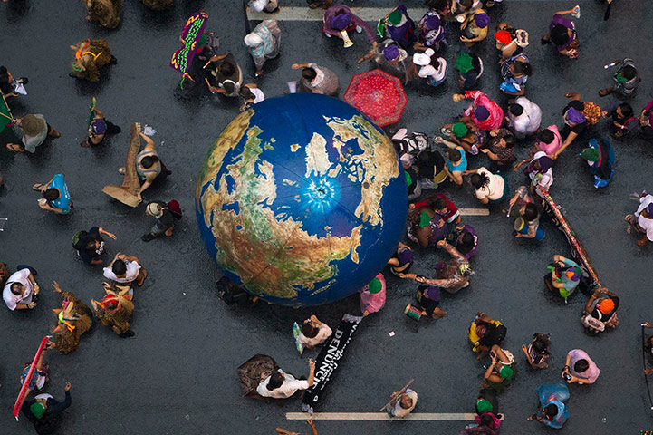rio+20: Activists push an inflatable globe during a 