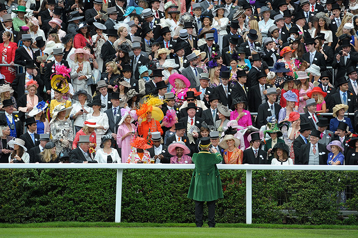 ladies day at ascot : A steward takes a picture for some racegoers  