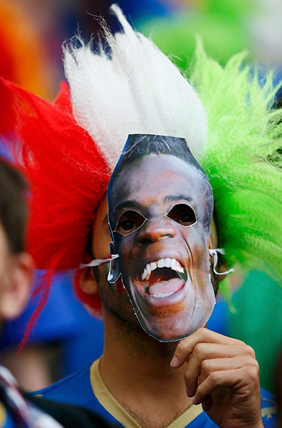Balotelli: Italian supporter wearing Mario Balotelli's face mask 