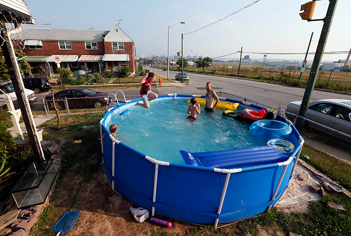 Picture desk live: Michaela Blankenship, age 9, jumps into a pool