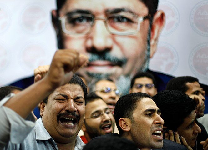 Egypt election results: Supporters of Mohamed Morsi celebrate in front of his picture