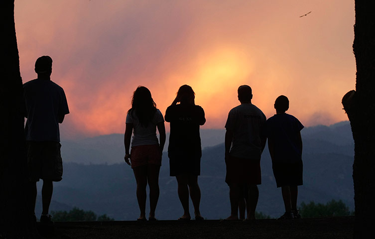 Picture desk live: People watch a giant smoke plume 