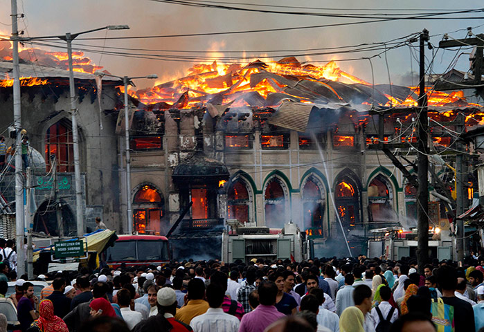 Picture desk live: A crowd watches firefighters try to extinguish a fire at an old Shrine