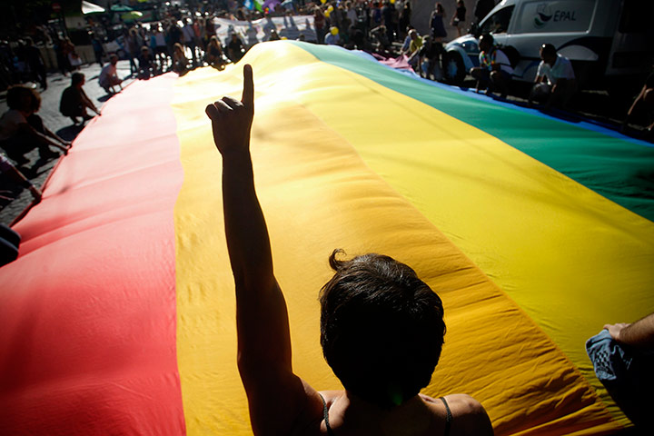 Gay pride week: Lisbon, Portugal: Revelers hold a giant flag during the parade