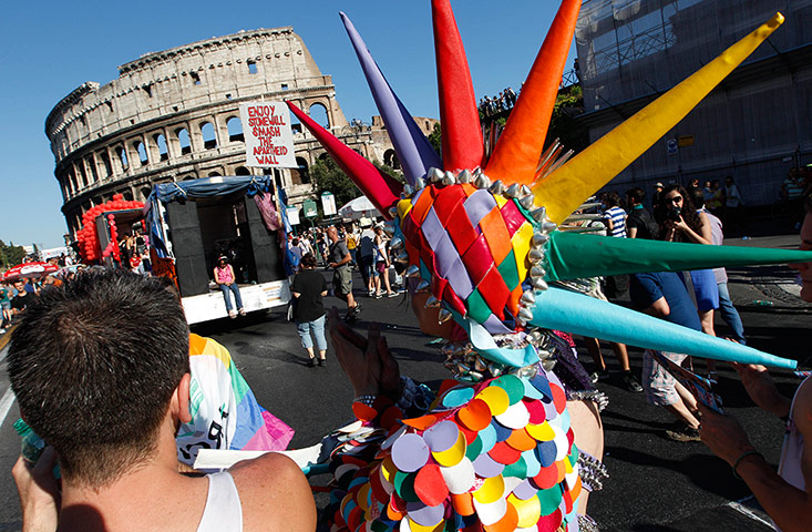 Gay pride week: Rome, Italy: Revelers march past the Colosseum