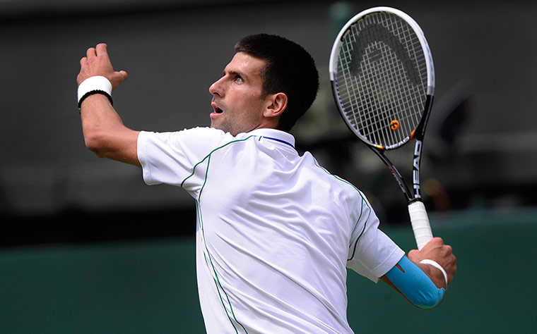 Wimbledon day 1: Novak Djokovic waits to smash