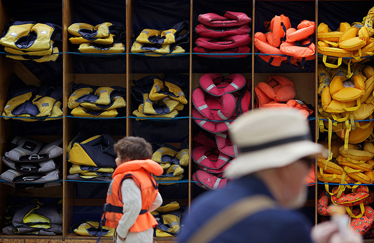 Picture desk live update1: TOPSHOTS A boy walks past shelves of lif