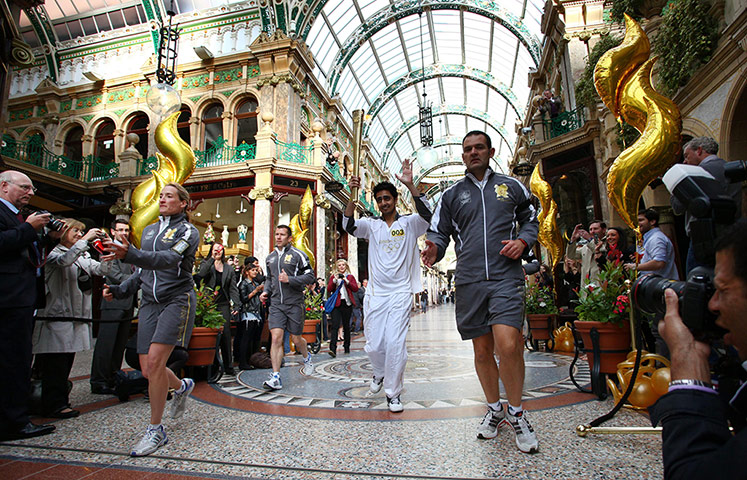 Olympic torch relay: Yasser Ranjha carries the Olympic Flame through the County Arcade in Leeds