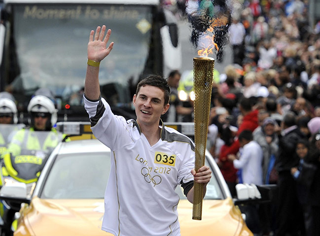 Olympic torch relay: Daniel Maynard waves on the leg between Batley and Dewsbury