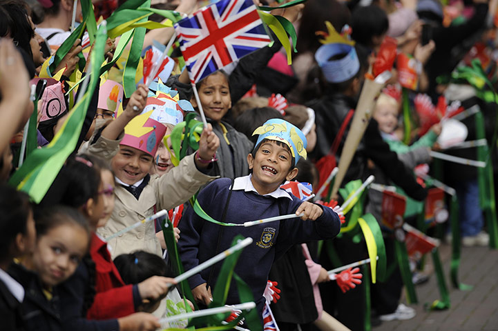 Olympic torch relay: These excited children cheer on the Torchbearers in Dewsbury