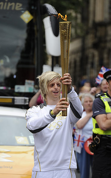 Olympic torch relay: Jonathan Lancaster carryies the Olympic flame through Wakefield