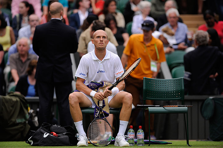 Day 3 Wimbledon: Nikolay Davydenko looks dejected at Wimbledon 2012