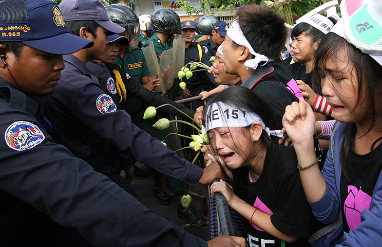 Picture desk live: Police block children from the squatter areas during a protest in Cambodia