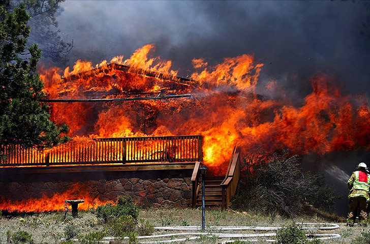 Wildfires in Colorado: A firefighter tackles the flames at Estes Park, Colorado