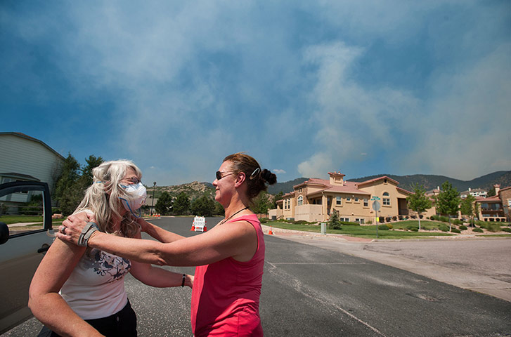 Wildfires in Colorado: People deal with the effect of smoke rising over Cascade