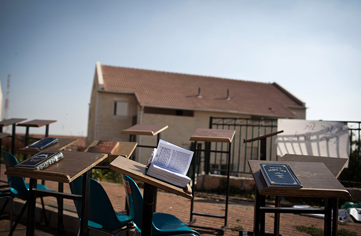 24 hours in pictures: Prayer books rest on tables in the Ulpana neighbourhood 