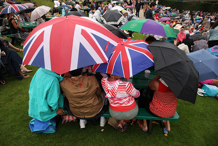 Picture desk live: The crowd shelter from the rain at Wimbledon