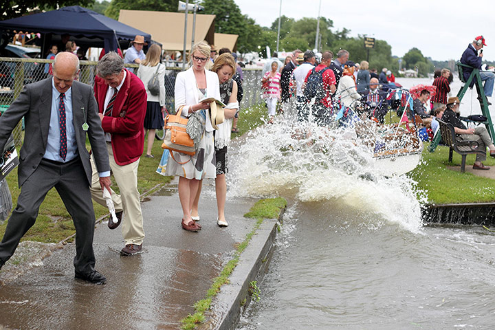 Picture desk live: spectators avoid getting the wash from a boat at the Henley Royal Regatta