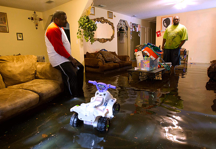 Picture desk live: Gordon McClain surveys his flooded living room in Live Oak, Florida