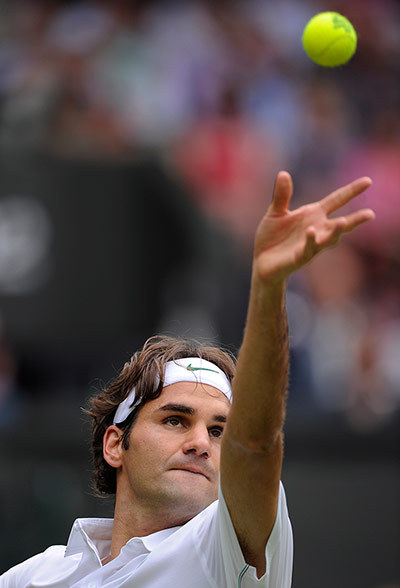 Day 3 Wimbledon: Roger Federer serves at Wimbledon 2012
