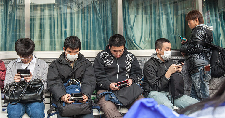 Your Pictures: Group of young men playing portable computer consoles