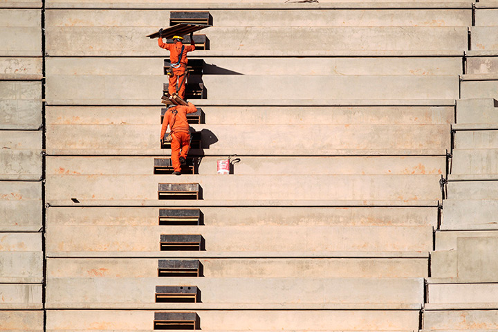 24 hours in pictures: Workers are seen inside the National Mane Garrincha Stadium
